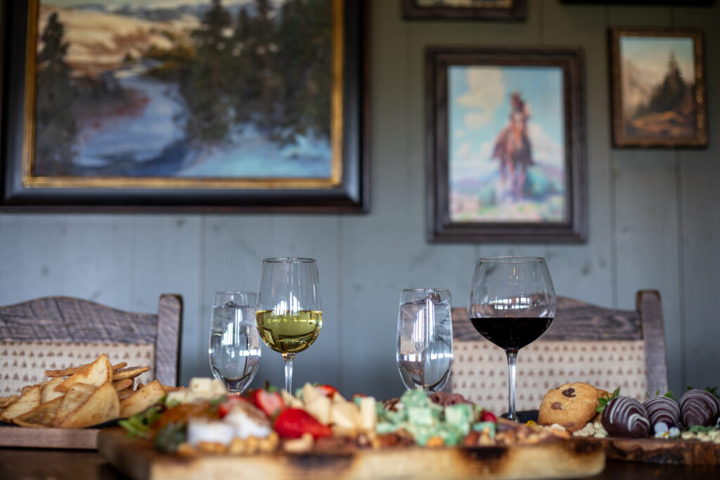 A table spread with food and wine.