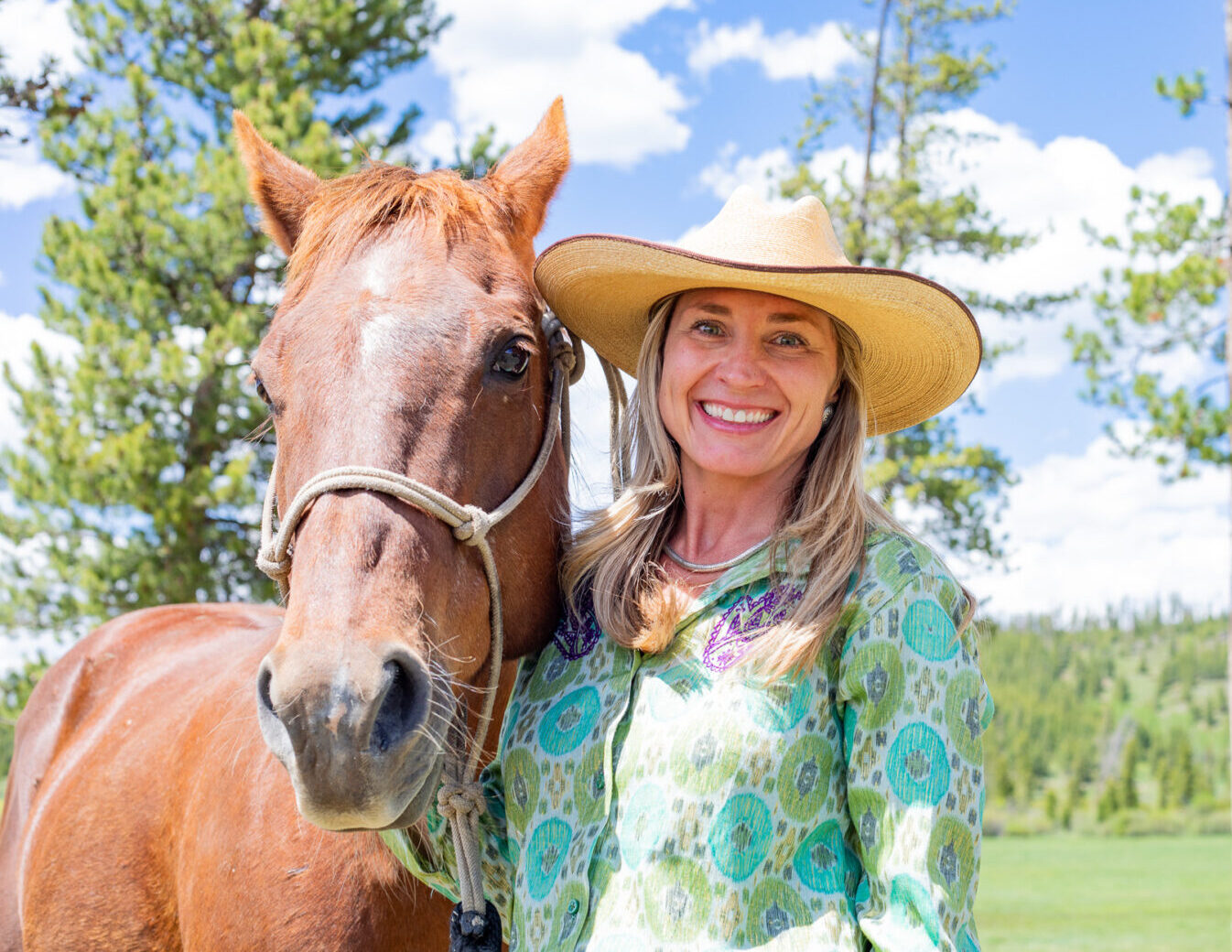 Woman smiles next to horse