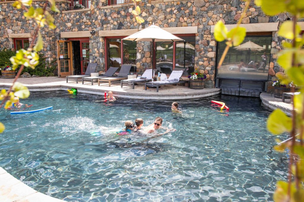 Families swim in an outdoor pool