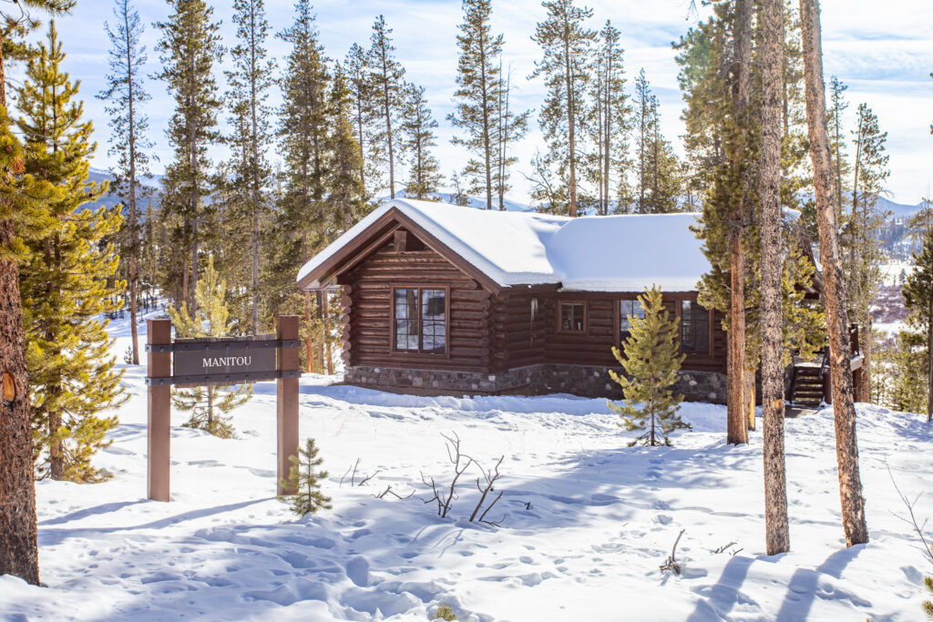 Manitou log cabin exterior in snowy forest