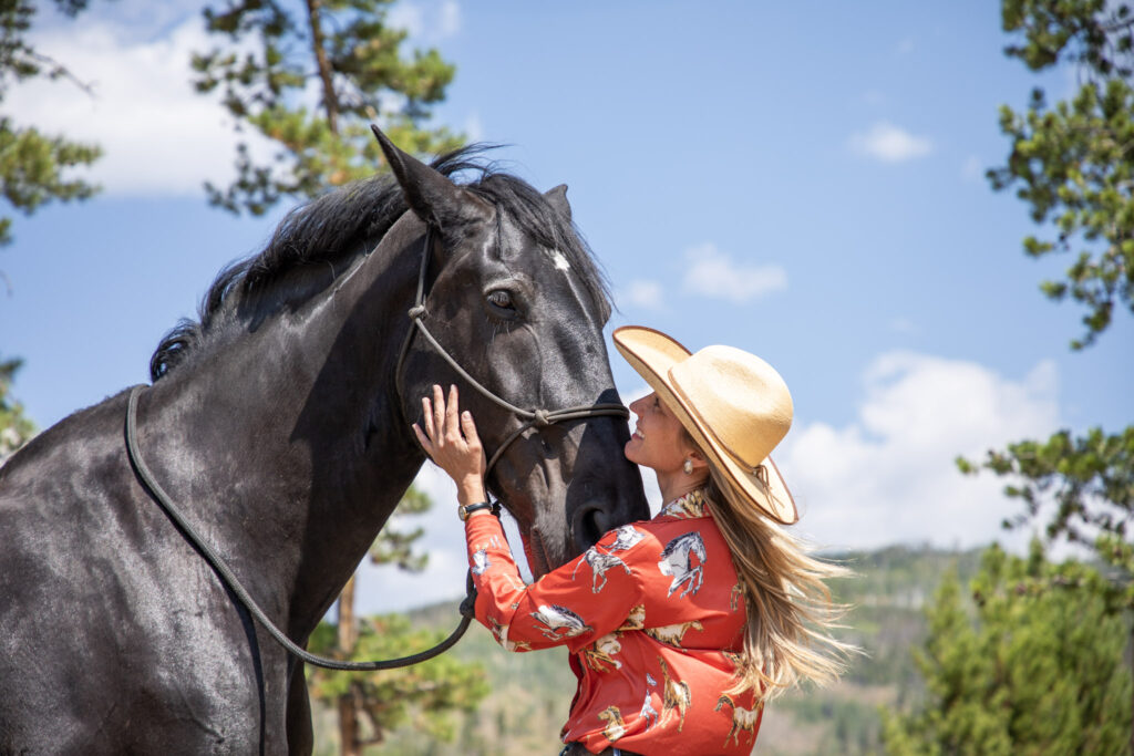 Woman smiles at horse