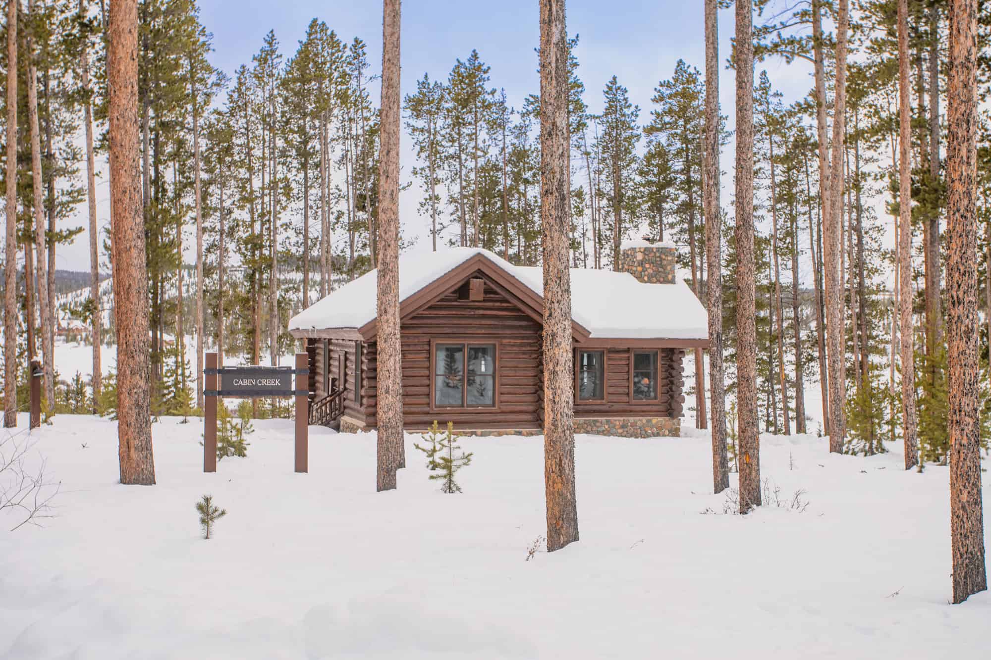Cabin in a snowy forest at Devil's Thumb Ranch Resort & Spa.