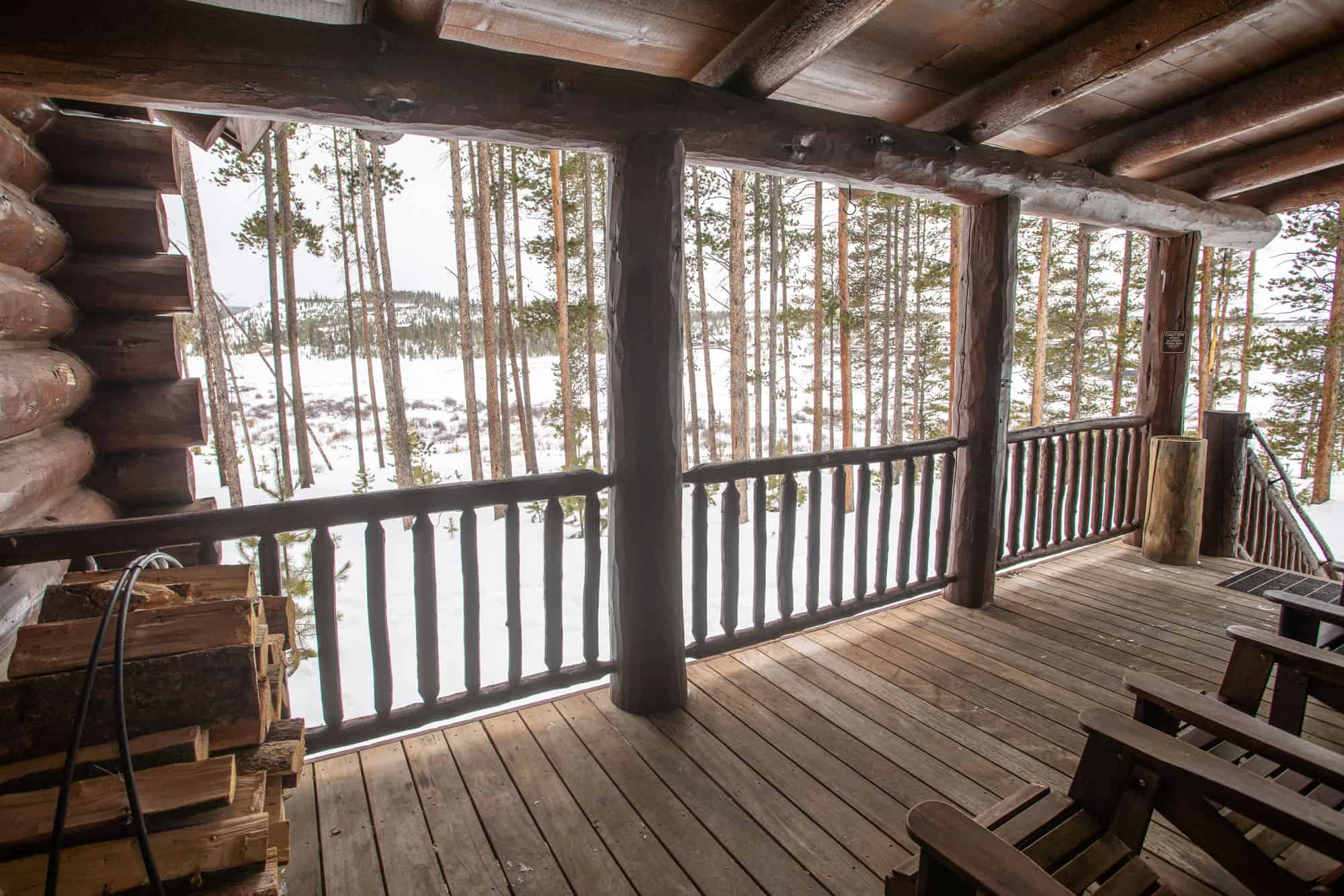 Balcony view at Devil's Thumb Ranch Resort & Spa overlooking snow-covered trees.