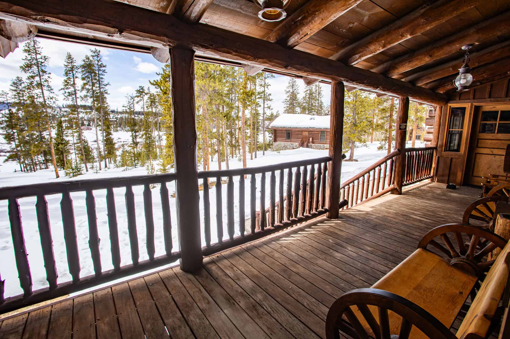Cozy wooden balcony overlooking snowy landscape at Devil's Thumb Ranch Resort & Spa.