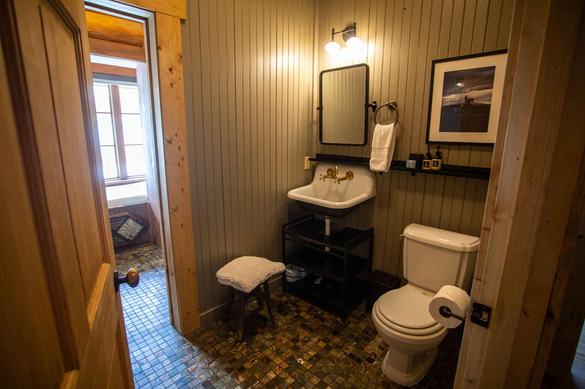 Cozy rustic bathroom at Devil's Thumb Ranch with vintage decor and wooden accents.