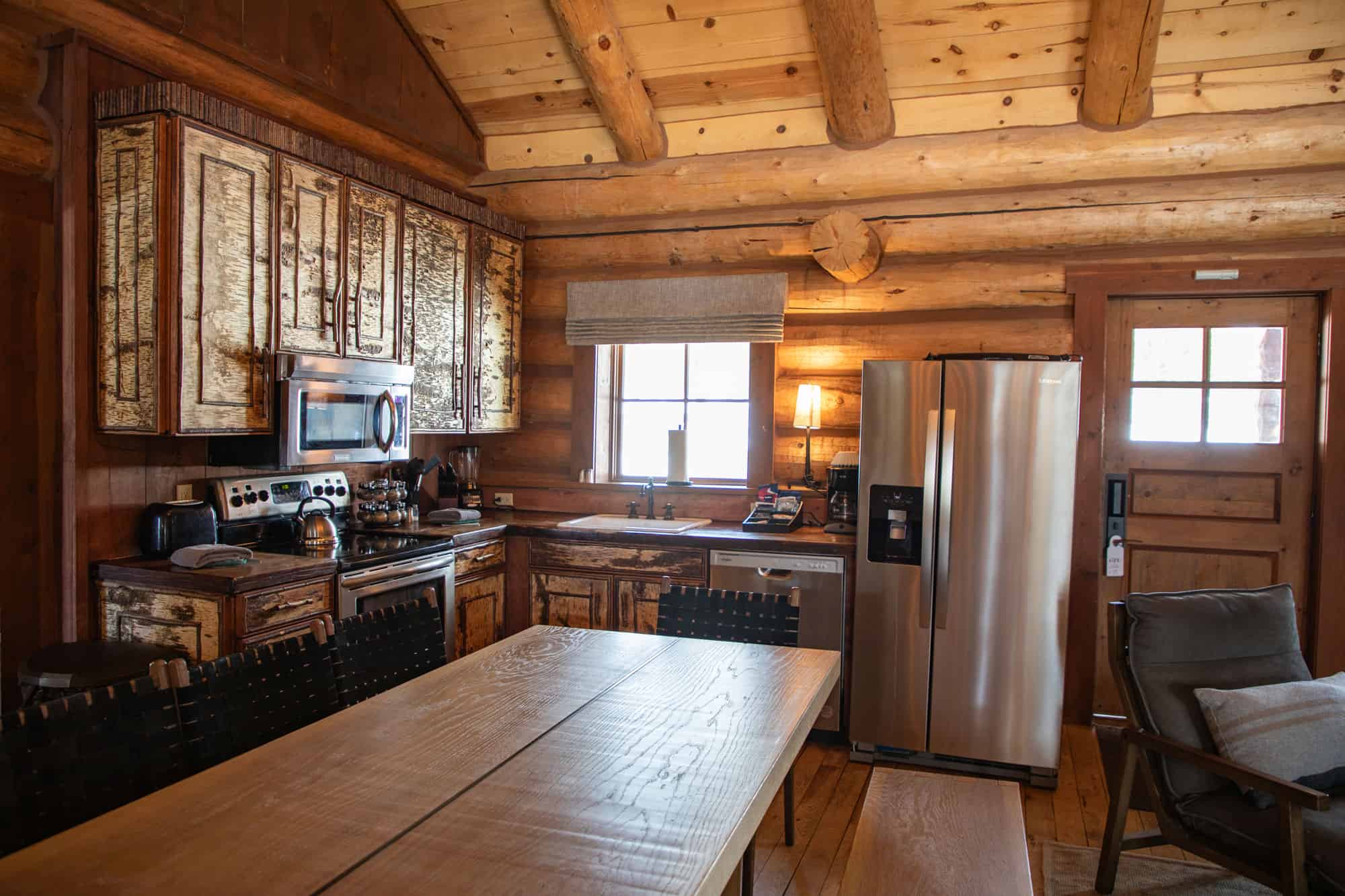 Cozy rustic kitchen at Devil's Thumb Ranch with wooden cabinets and modern appliances.