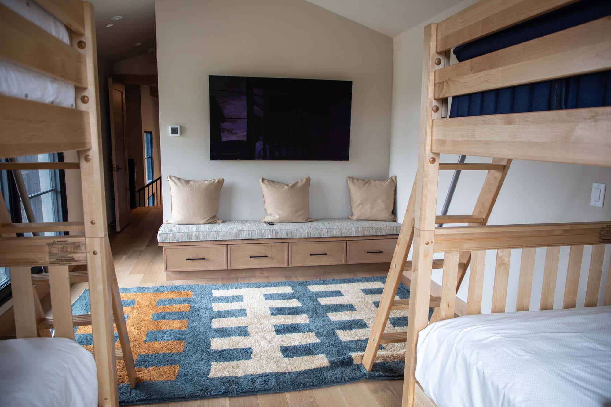Cozy bedroom with bunk beds and a sitting area at Devil's Thumb Ranch Resort & Spa.