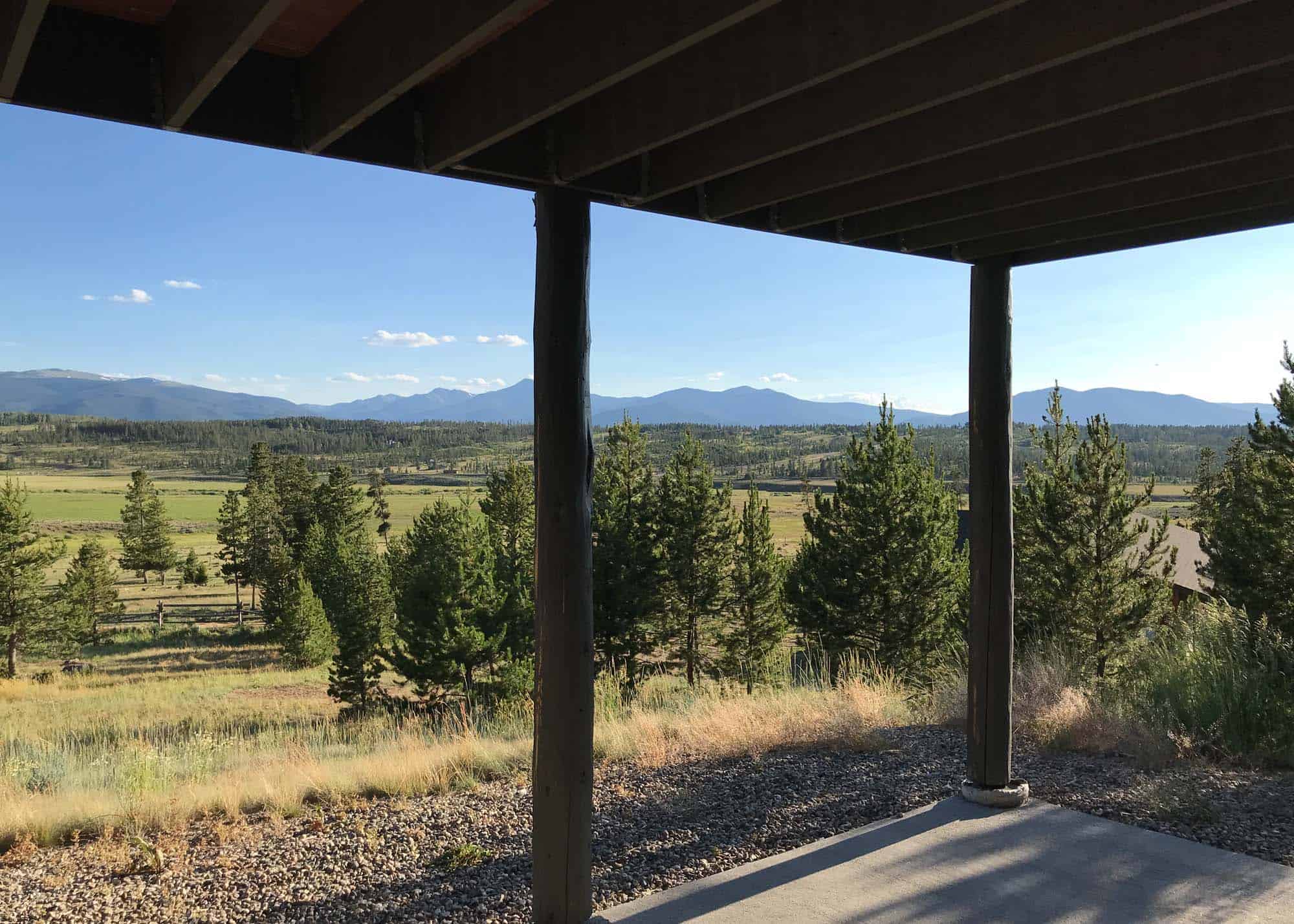 Beautiful mountain landscape seen from beneath a wooden deck.