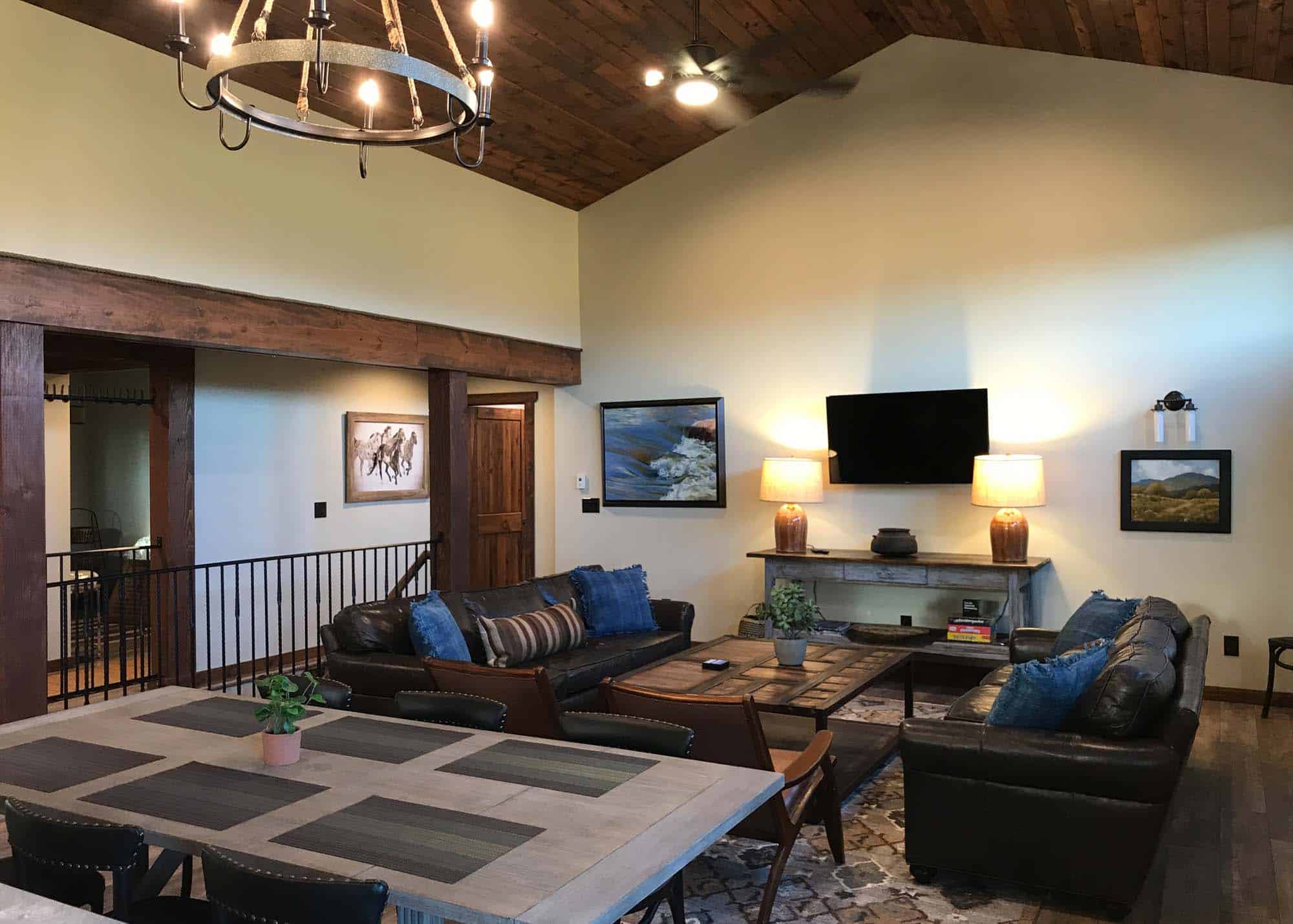 Cozy living room with leather sofas, wooden accents, and modern decor at Devil's Thumb Ranch.