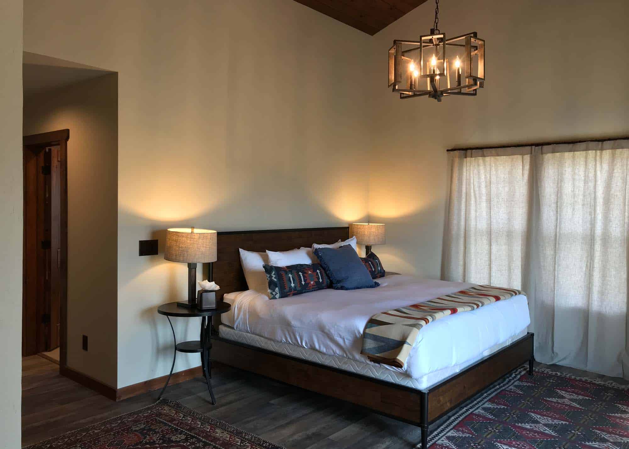 Cozy bedroom at Devil's Thumb Ranch with modern decor and warm lighting.