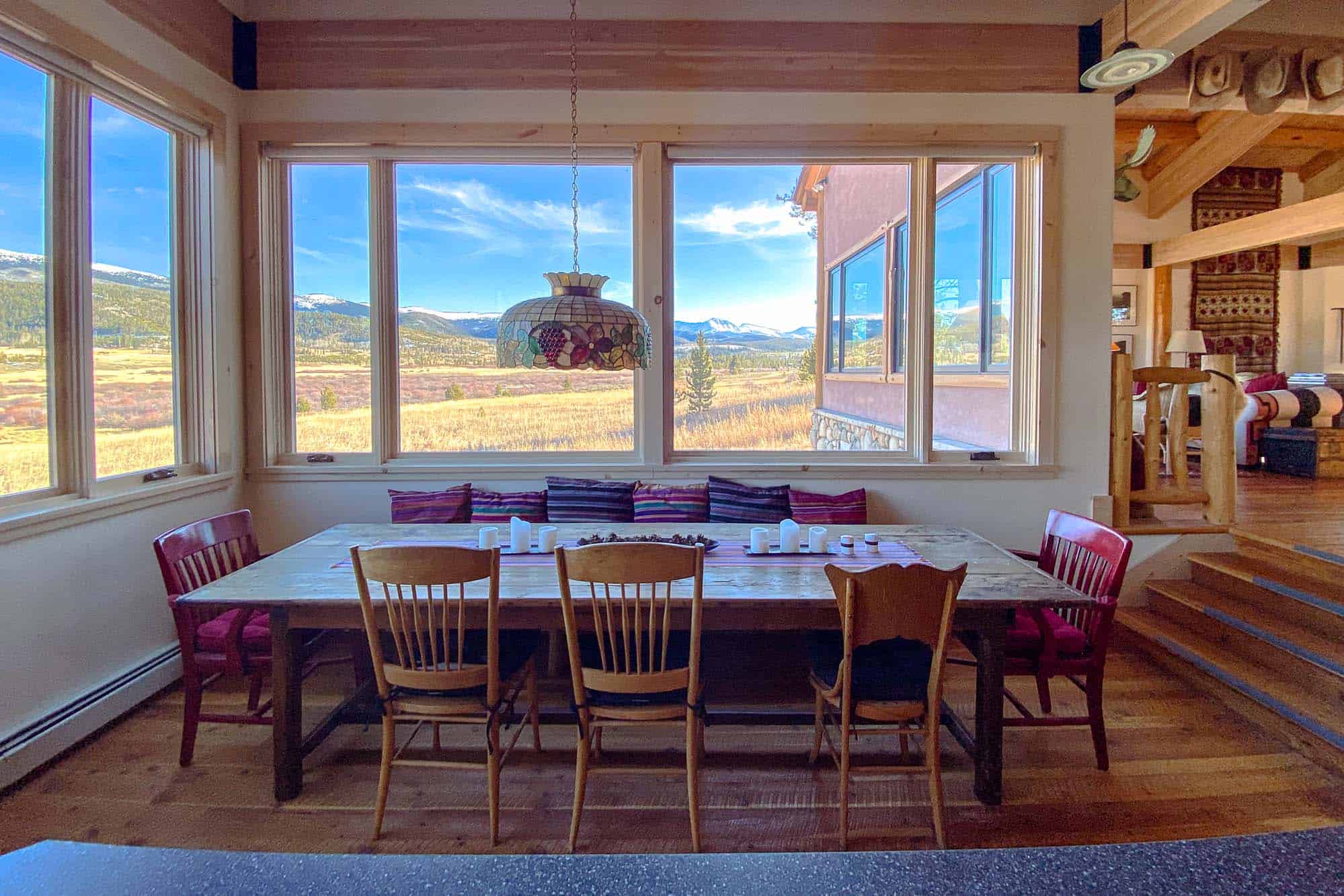 Cozy dining room with large windows and mountain views at Devil's Thumb Ranch.