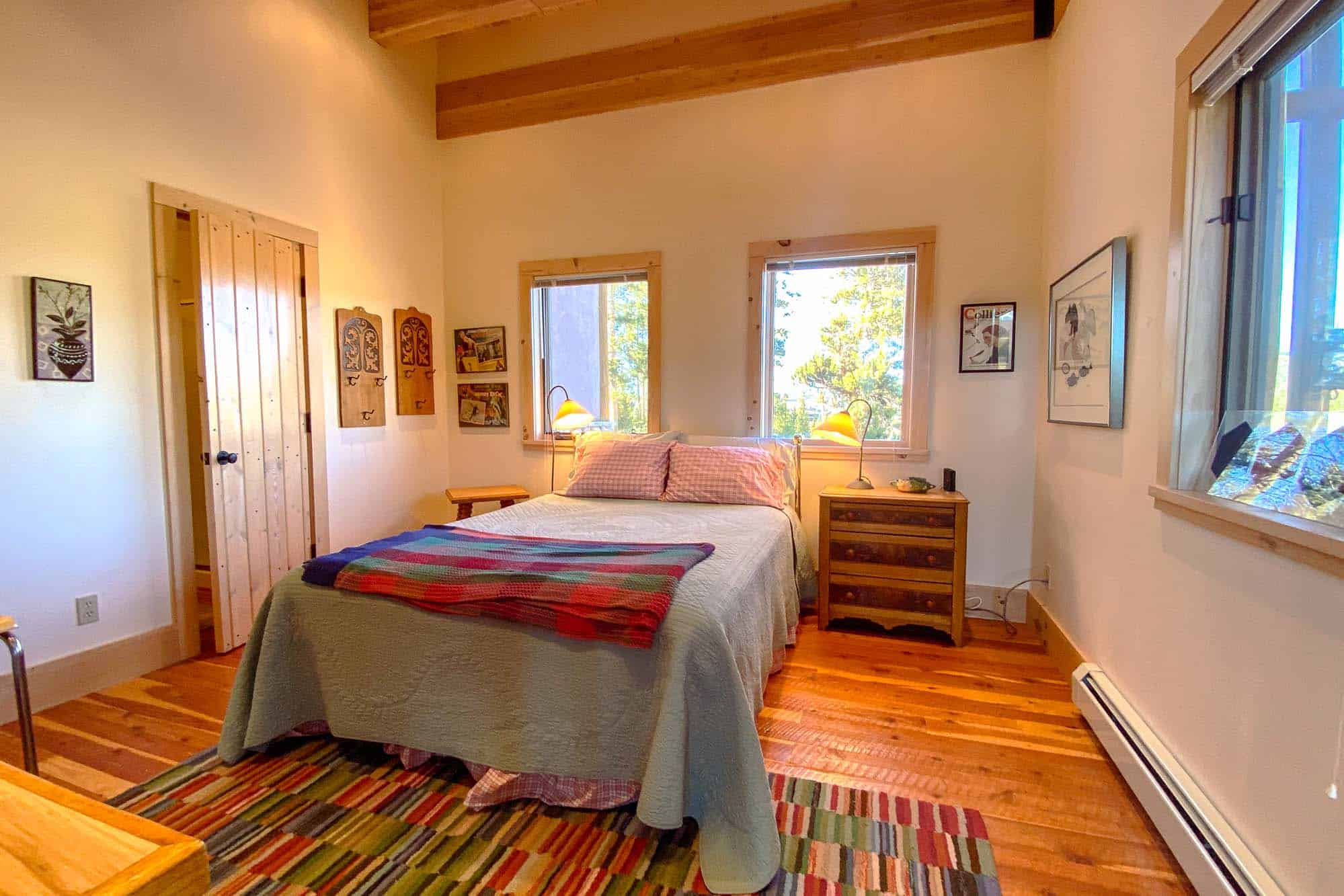 Comfortable bedroom with wooden accents and natural light at Devil's Thumb Ranch Resort & Spa.