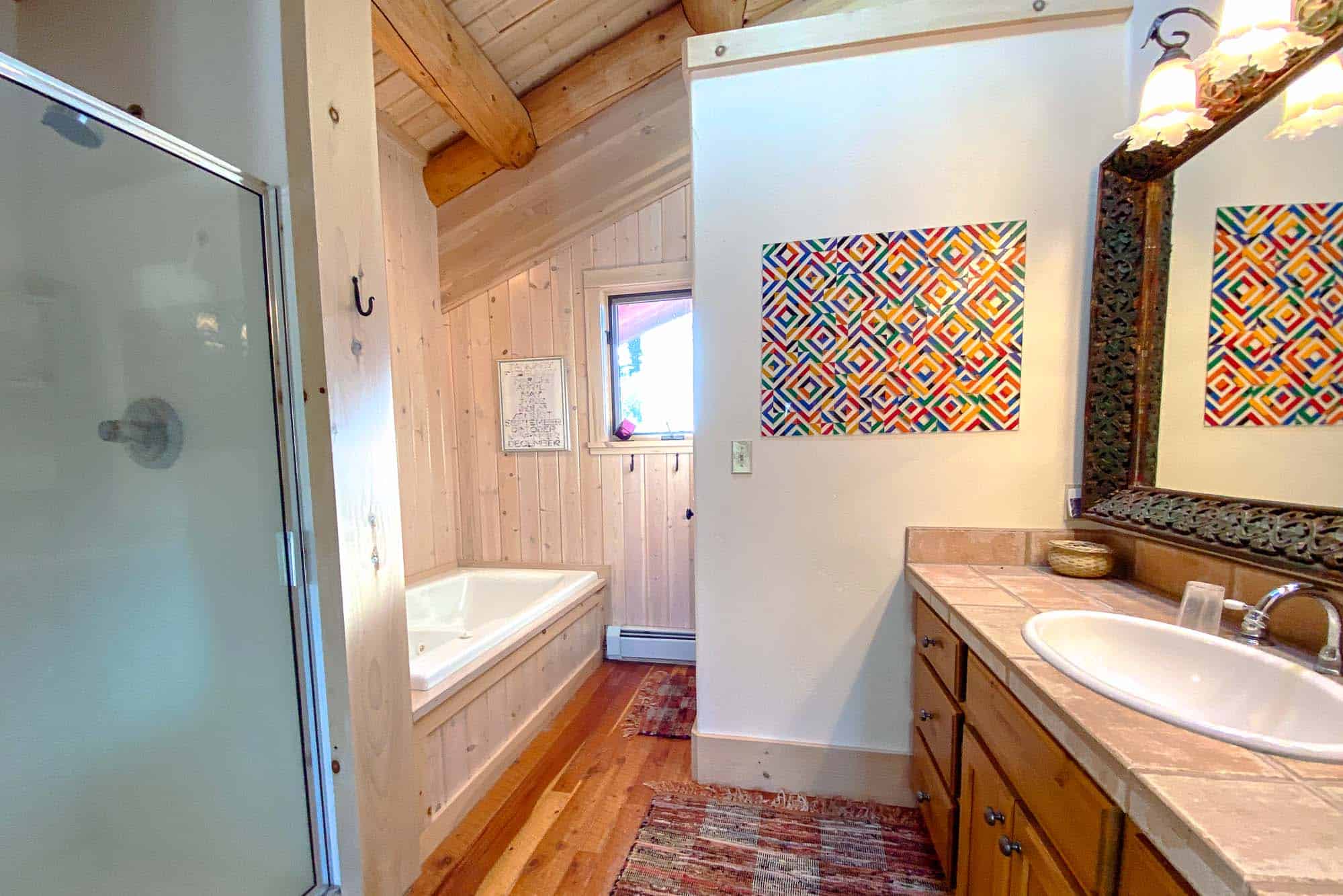 Bright bathroom with a bathtub and shower at Devil's Thumb Ranch Resort & Spa.