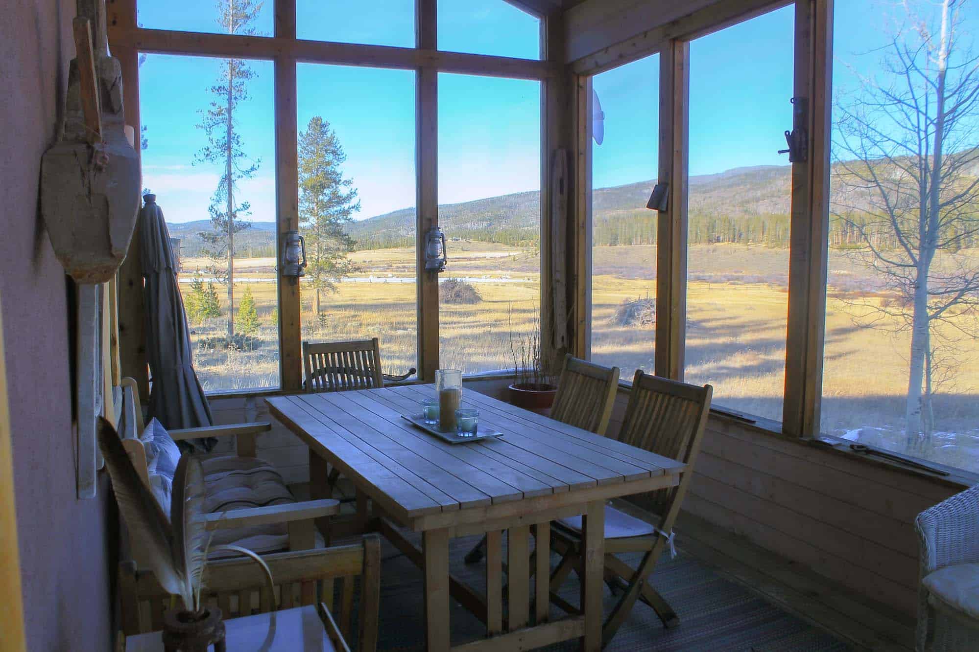Indoor dining space with large windows overlooking scenic mountain views.