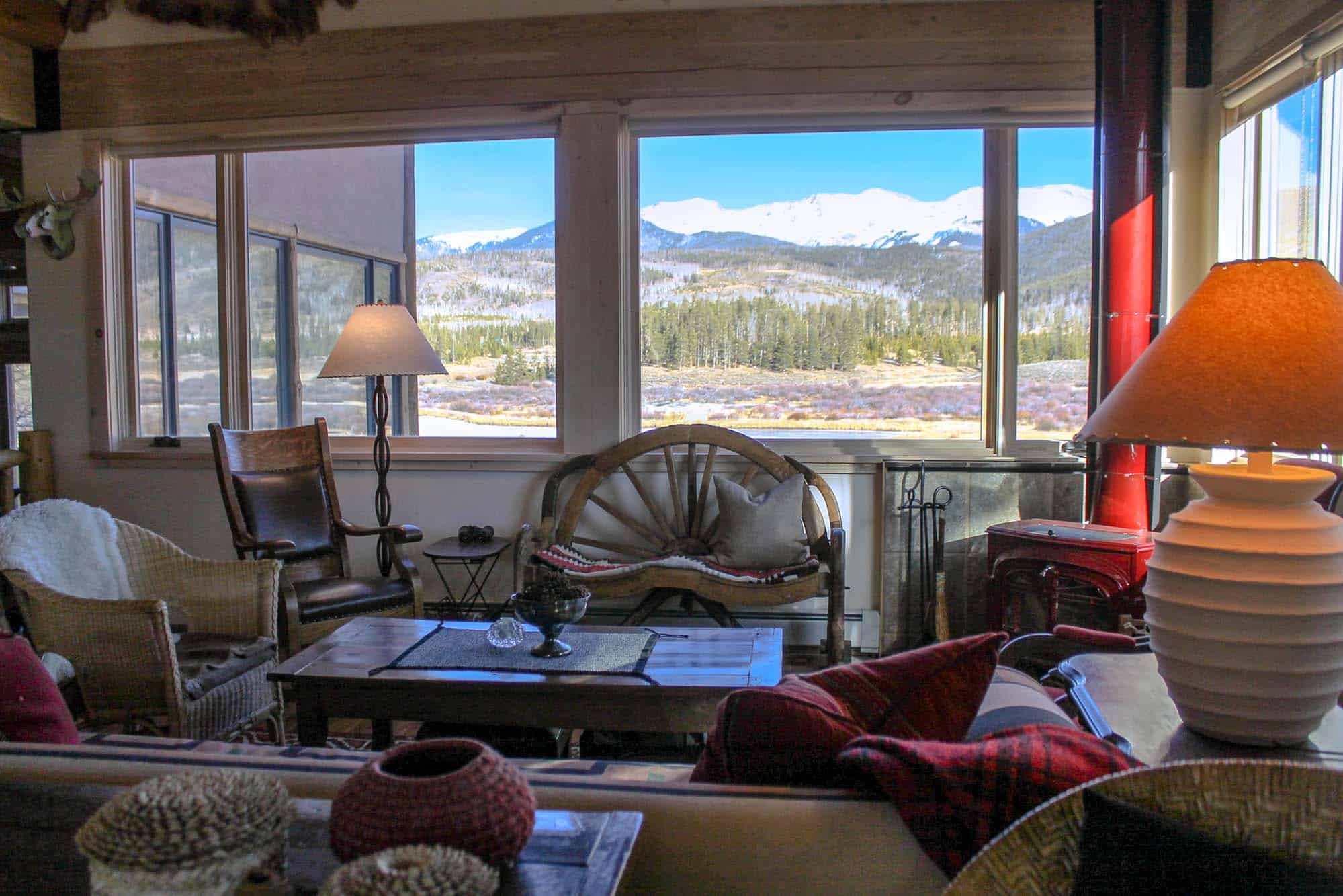 Cozy living room with large windows showcasing mountain views at Devil's Thumb Ranch Resort & Spa.