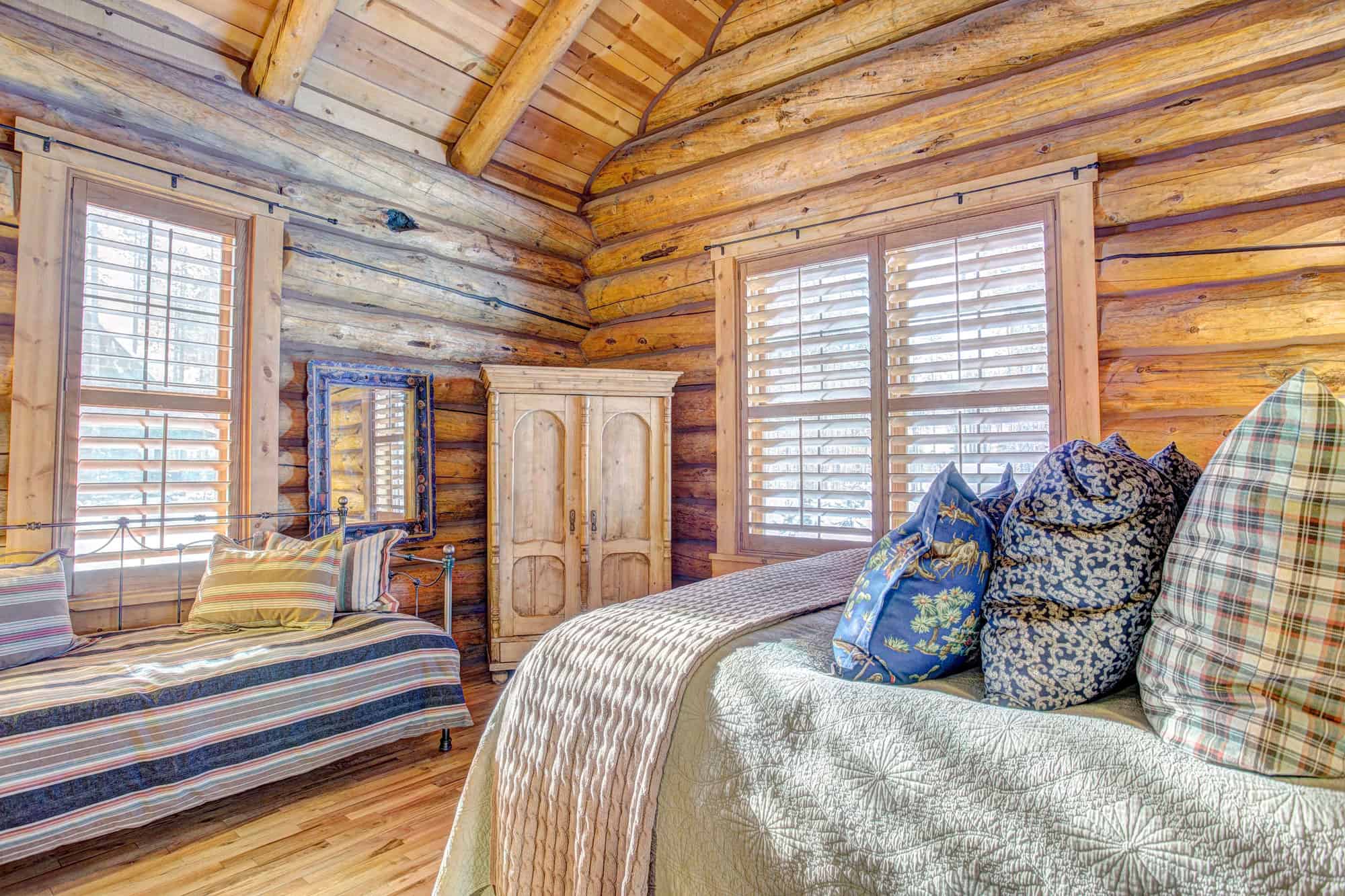 Interior view of a cozy rustic bedroom at Devil's Thumb Ranch Resort & Spa.