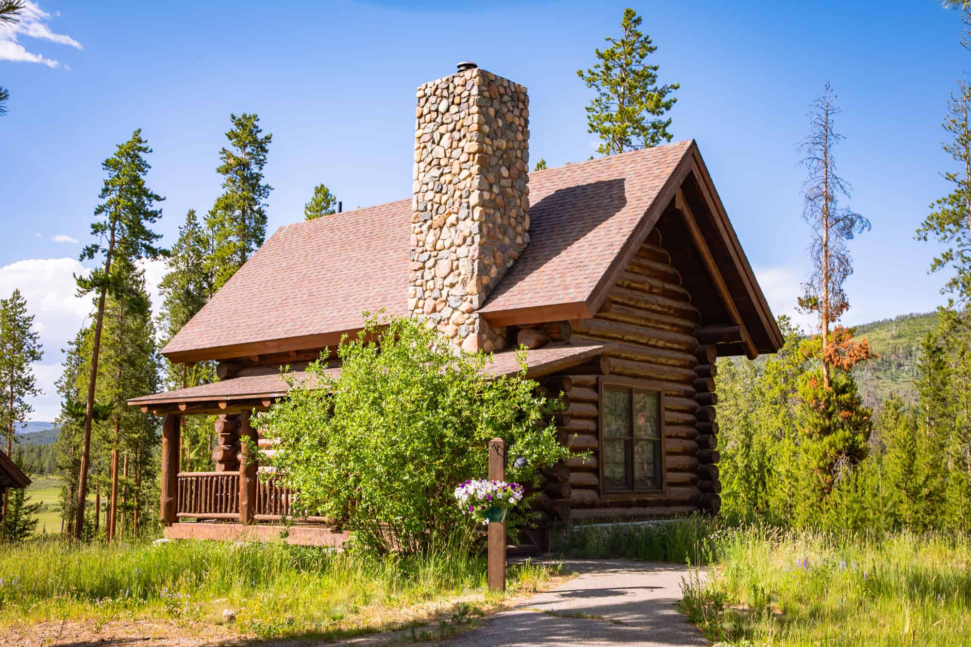 Cozy log cabin with stone chimney at Devil's Thumb Ranch Resort & Spa.