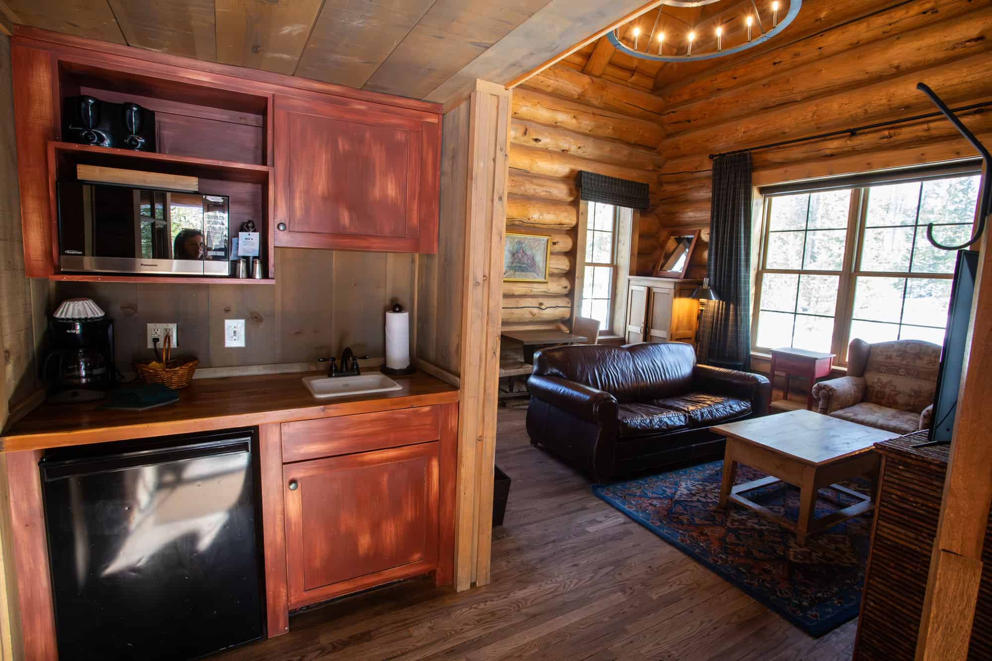Interior view of a cozy log cabin living area at Devil's Thumb Ranch Resort & Spa.