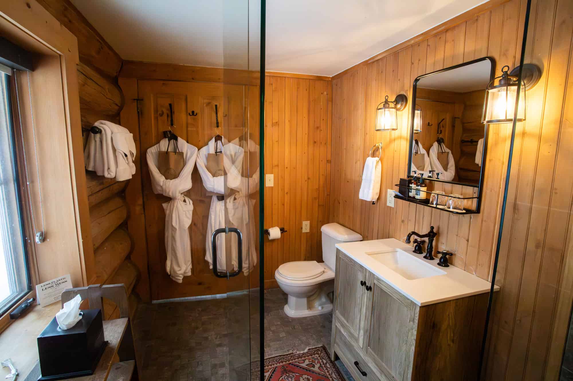 Rustic bathroom with wooden walls, modern sink, and cozy decor at Devil's Thumb Ranch.