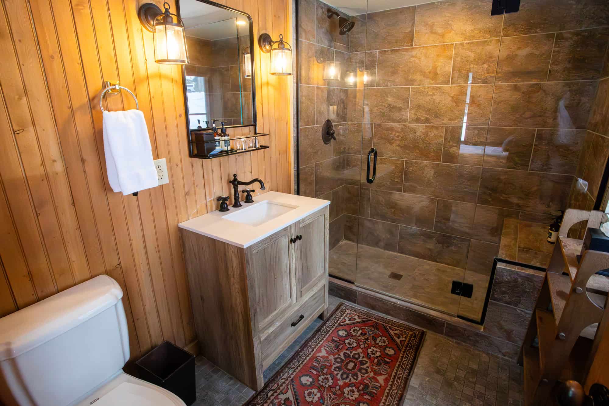 Cozy bathroom with wooden accents and modern fixtures at Devil's Thumb Ranch.