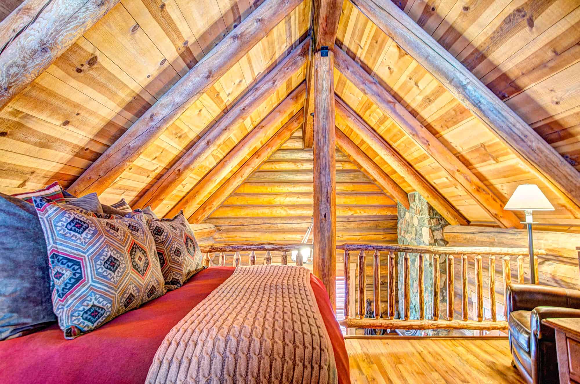 Interior of a cozy log cabin bedroom at Devil's Thumb Ranch.