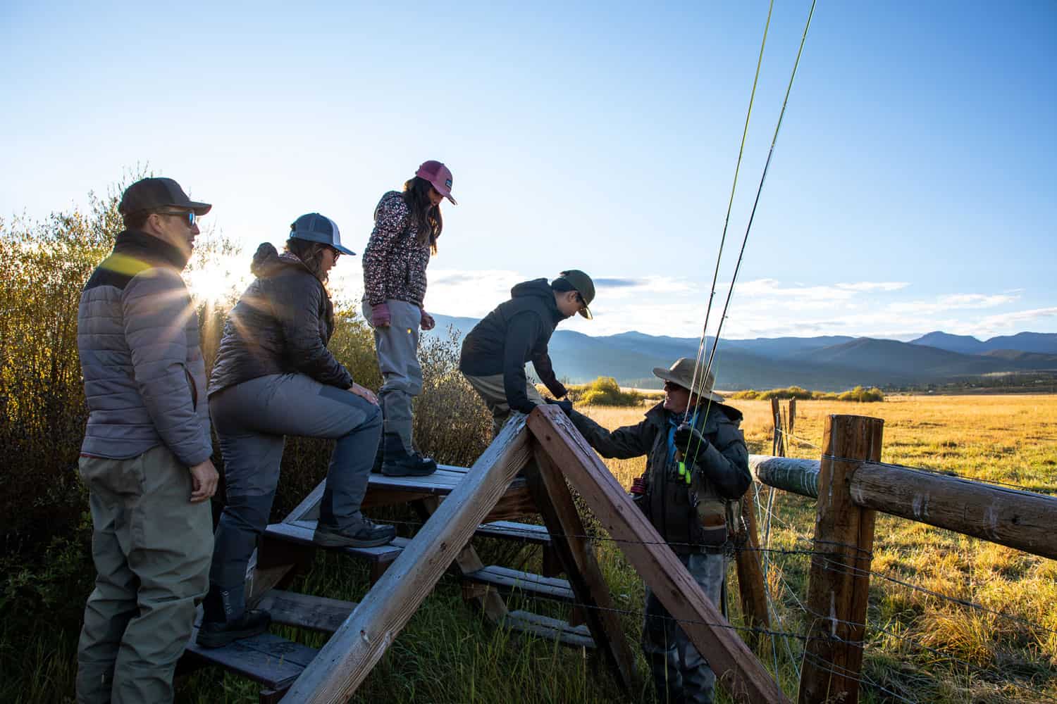 Group of people preparing to hike in scenic mountain landscape at Devil's Thumb Ranch.