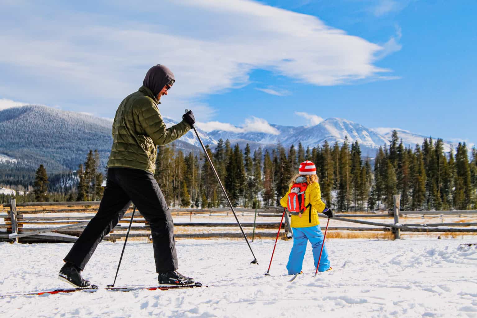 Family skiing in snowy mountains at Devil's Thumb Ranch Resort & Spa.