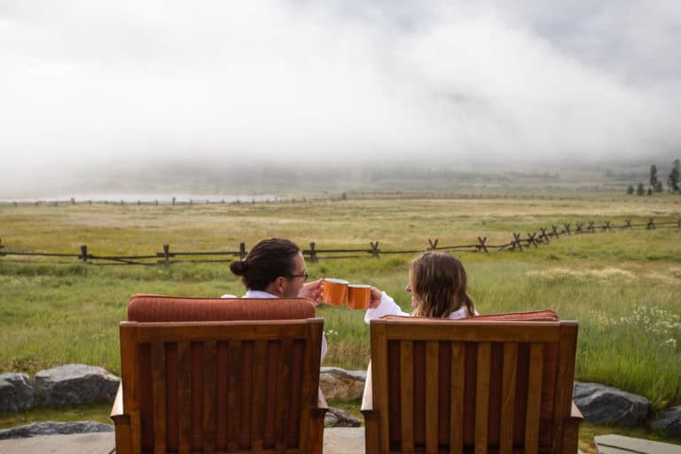 Scenic view of a woman and child relaxing outdoors at Devil's Thumb Ranch, enjoying the peaceful mou.