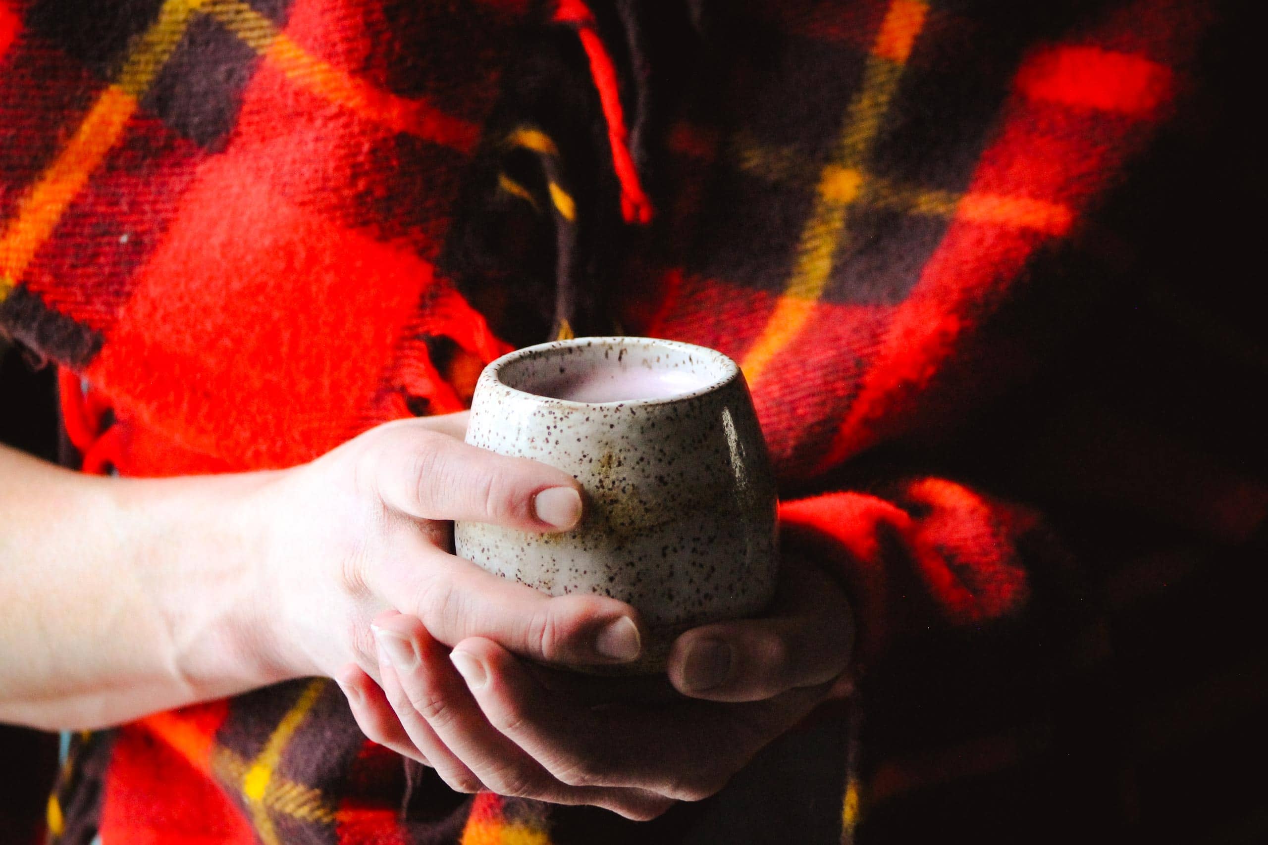 Person holding a coffee mug at Devil's Thumb Ranch Resort & Spa.
