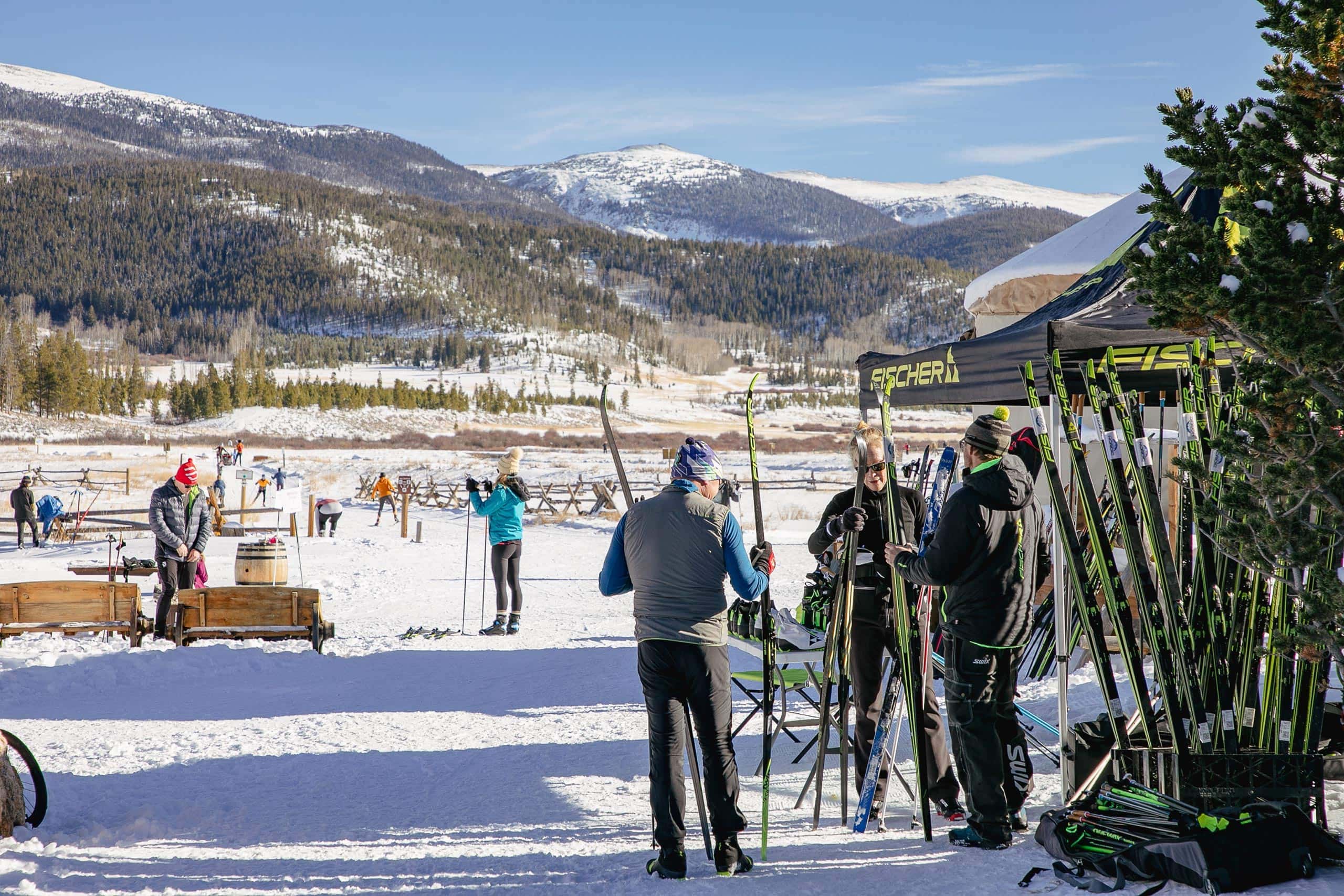 Skiers and snowboarders at Devil's Thumb Ranch Resort in winter snow.
