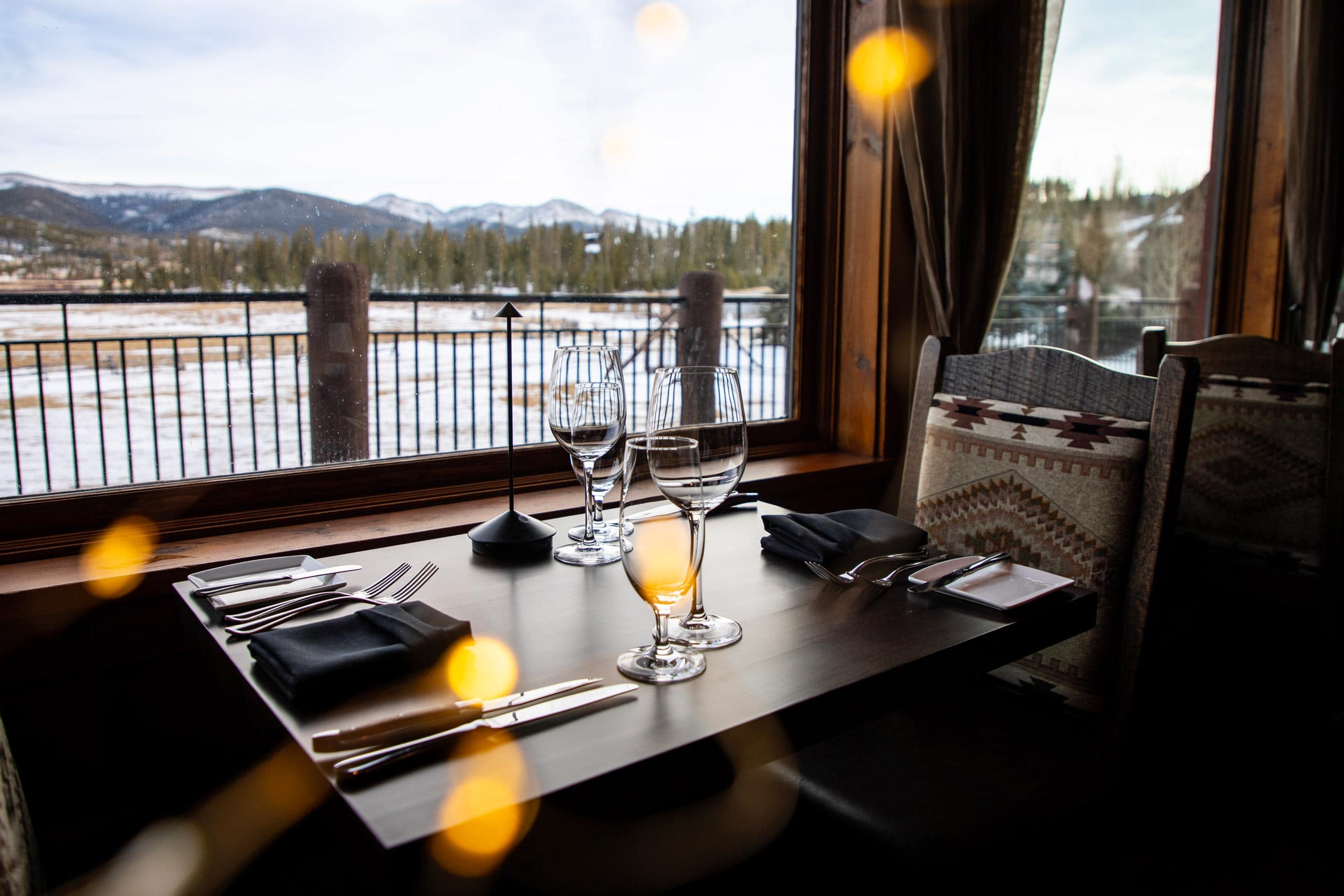 Elegant dining table with mountain view at Devil's Thumb Ranch.