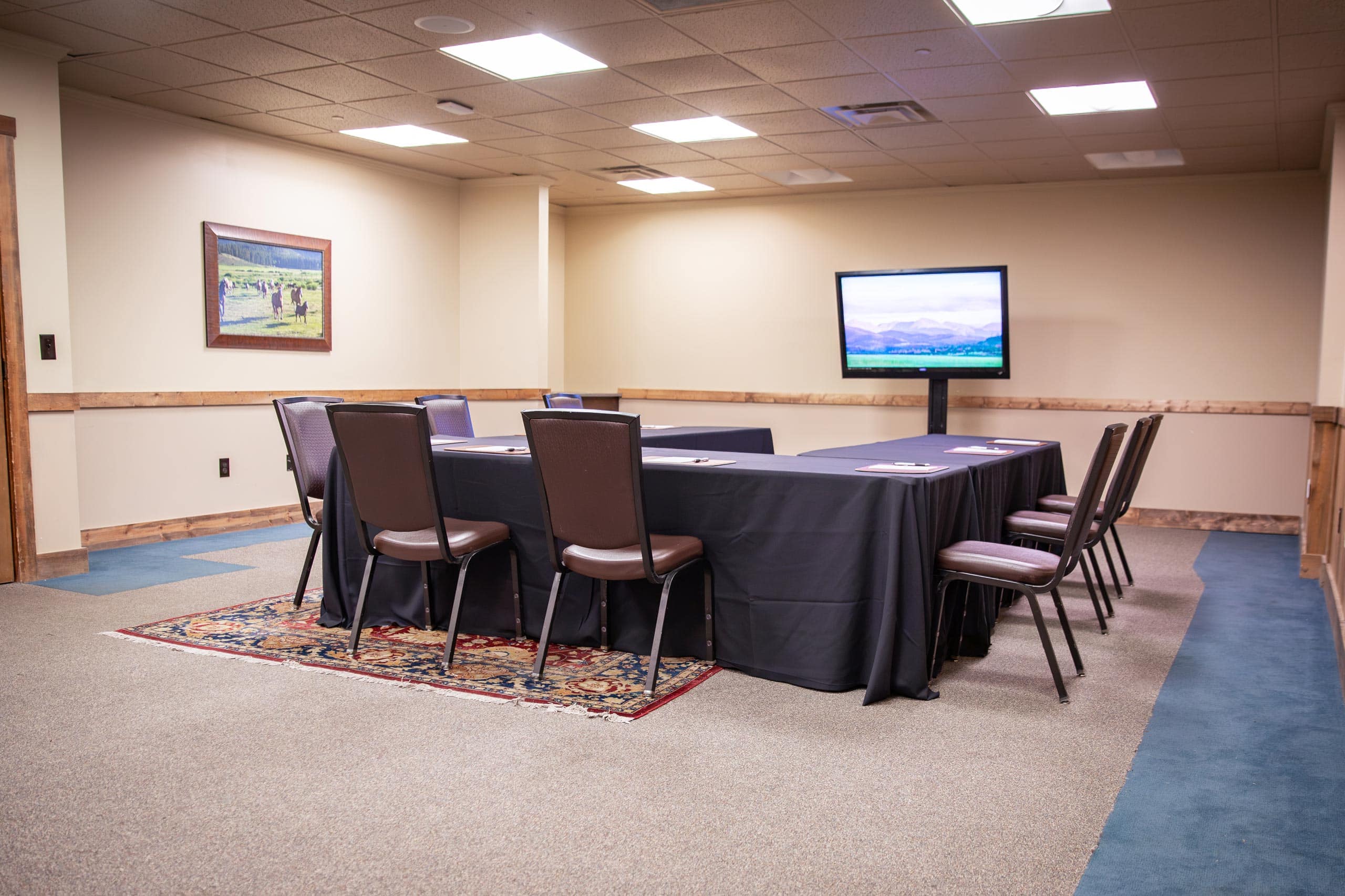 Conference room at Devil's Thumb Ranch Resort & Spa with TV and chairs.