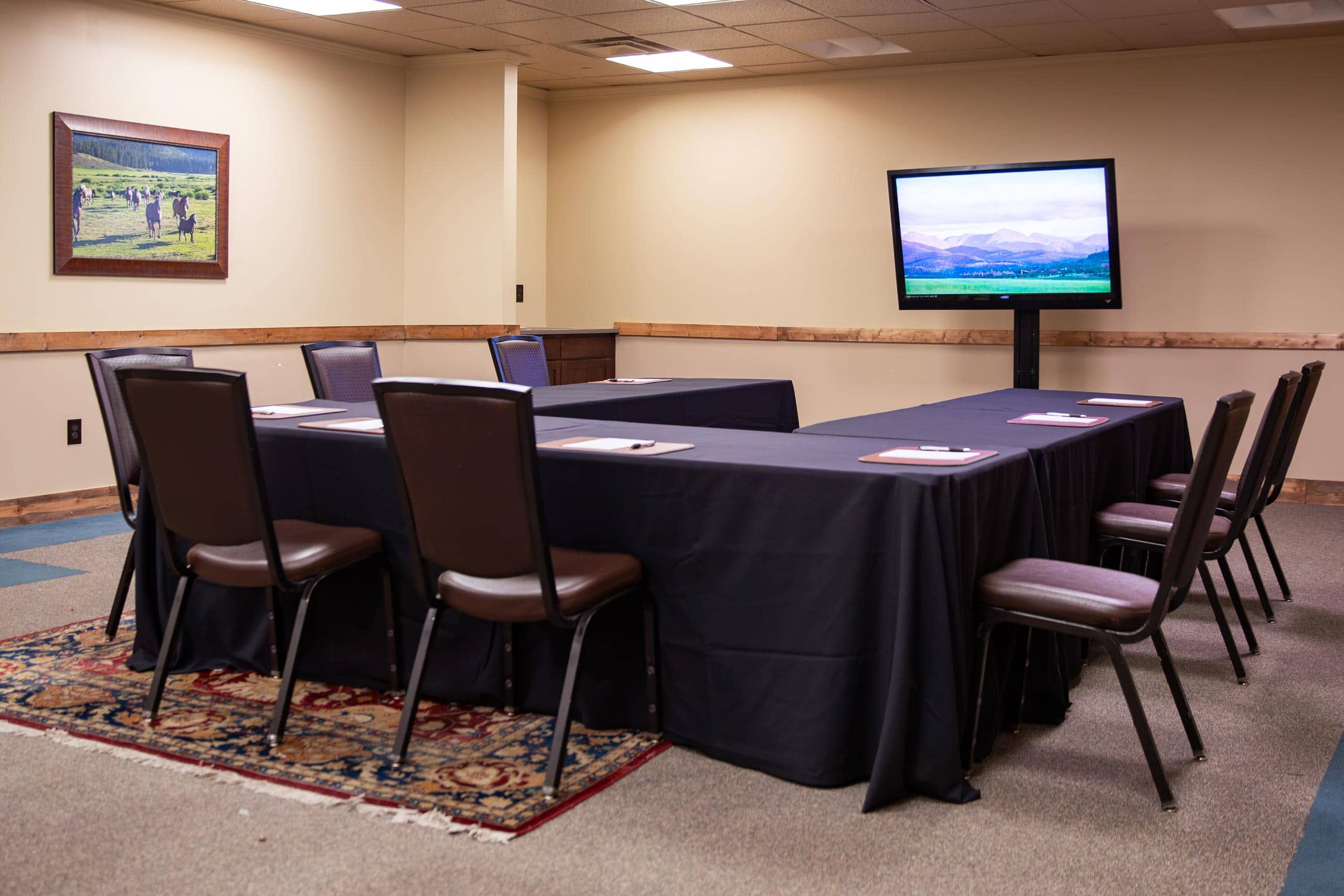 Conference room at Devil's Thumb Ranch with TV and seating.