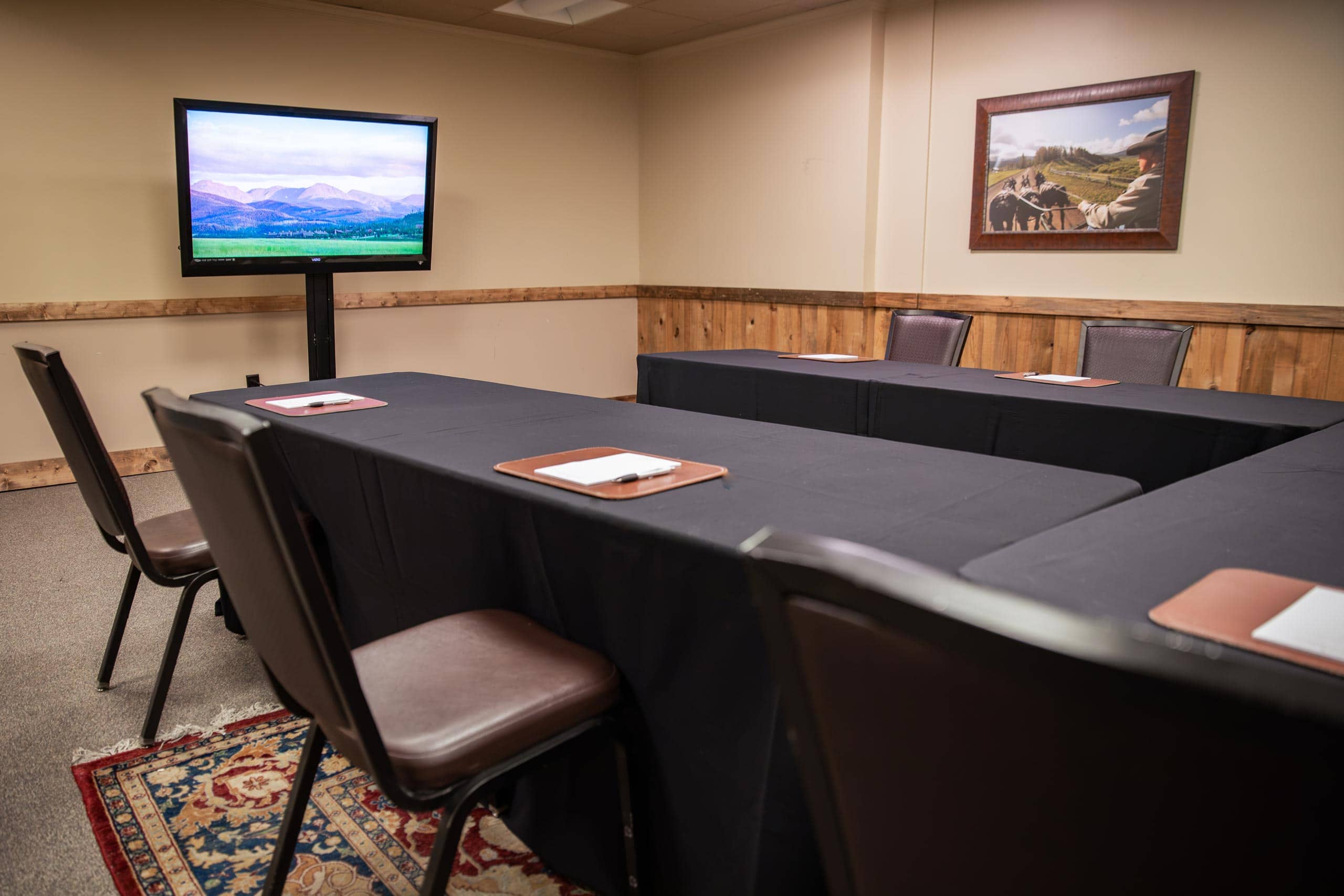Conference room at Devil's Thumb Ranch with TV and seating.