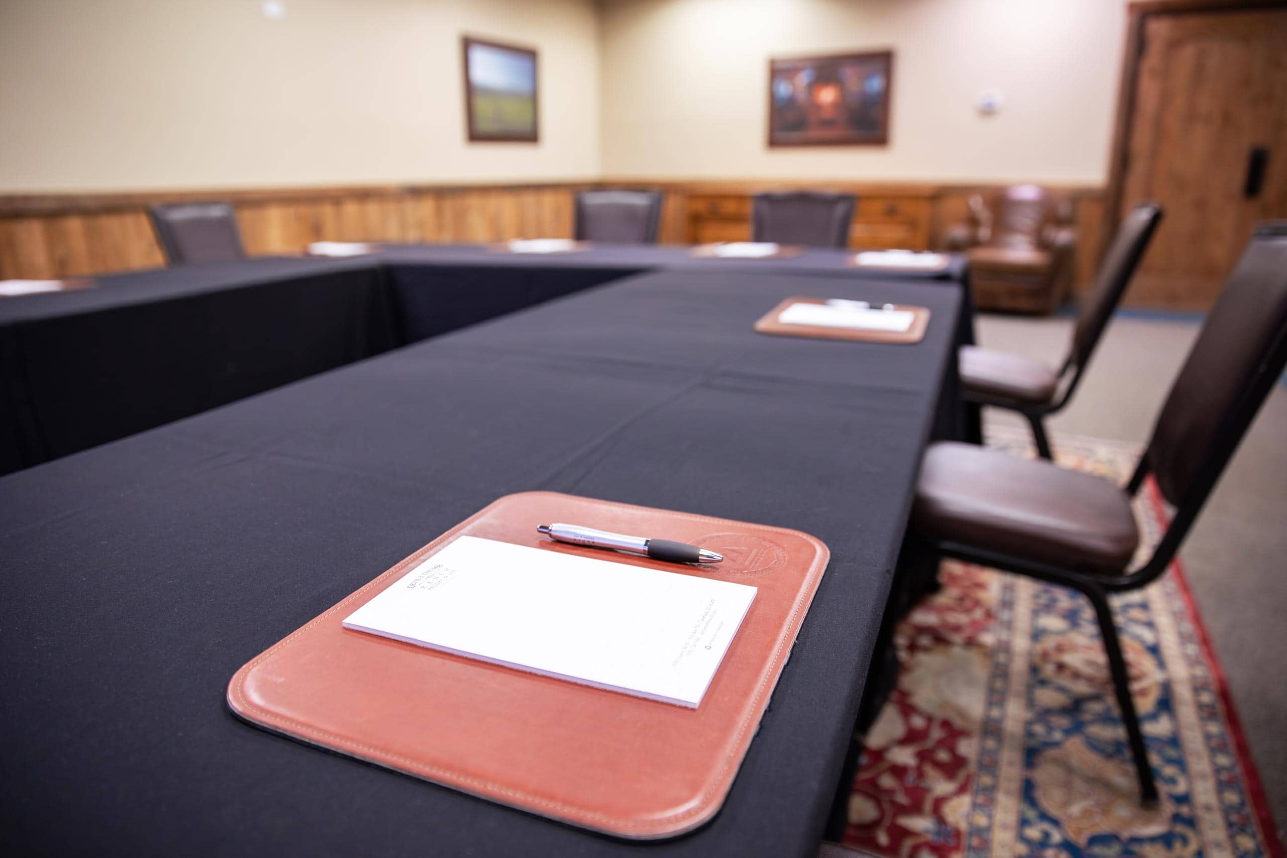 Conference room at Devil's Thumb Ranch with notepads and chairs.