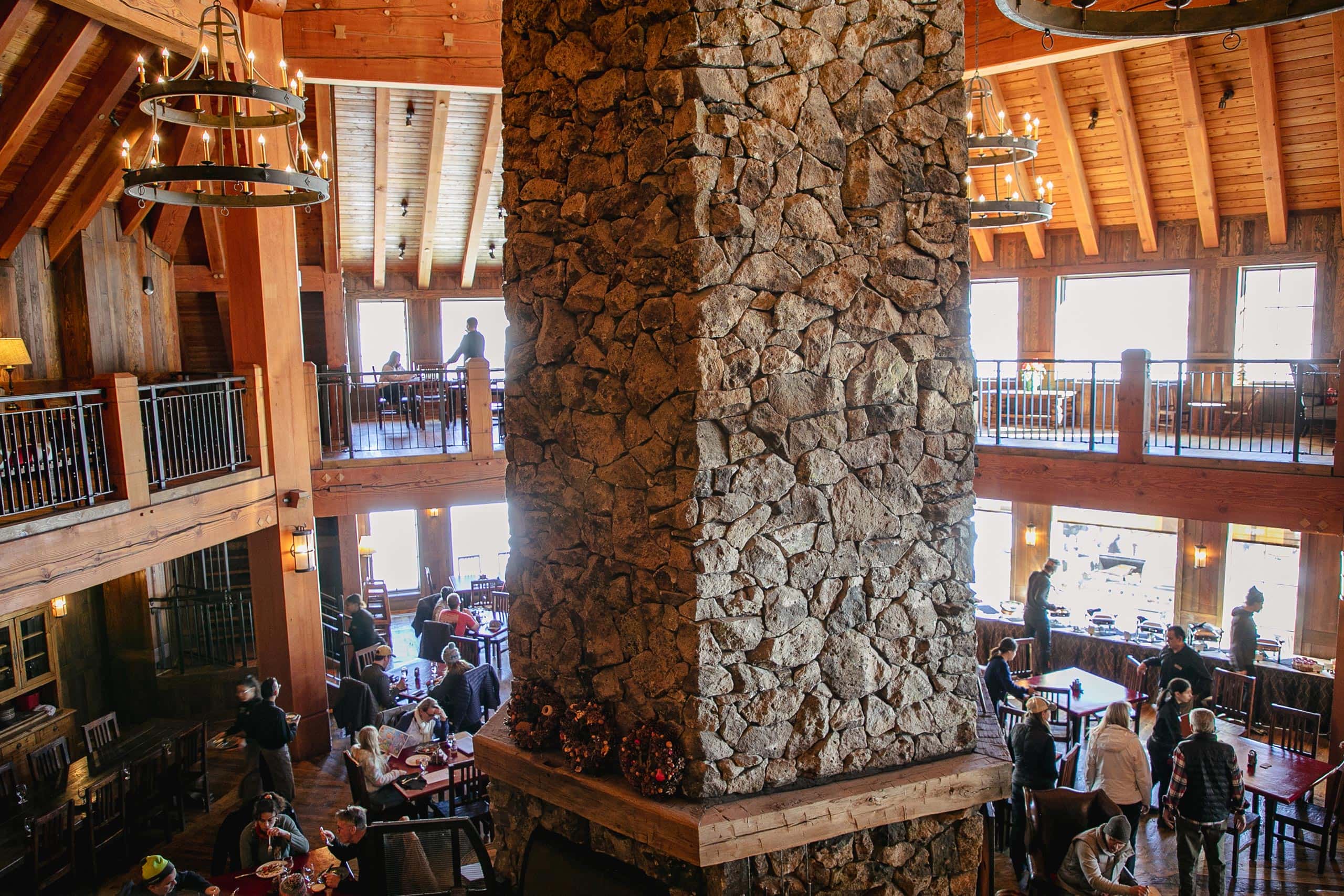 Interior view of Devil's Thumb Ranch Resort with stone fireplace and wooden architecture.
