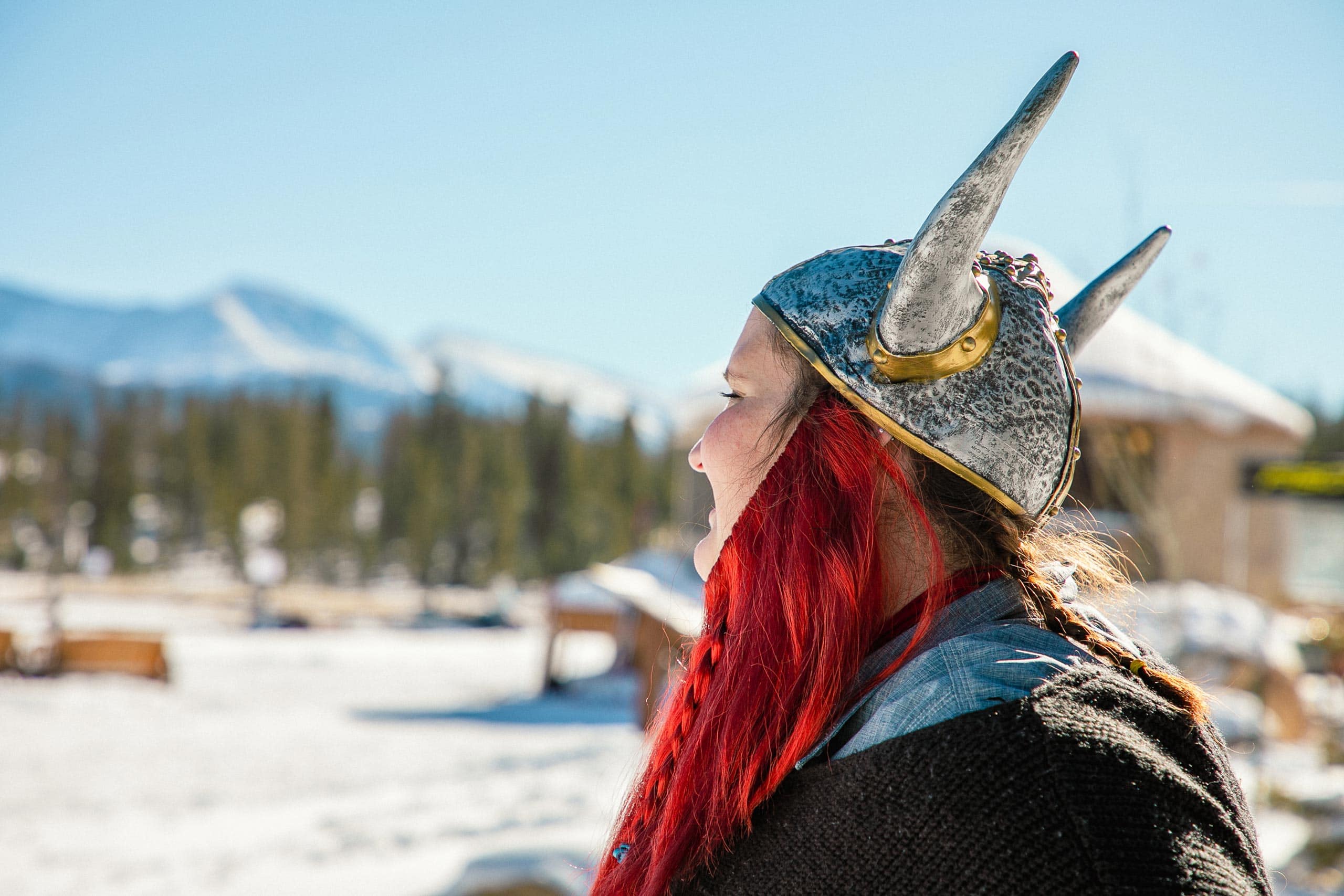 Woman in Viking helmet with red hair at Devil's Thumb Ranch in snow.