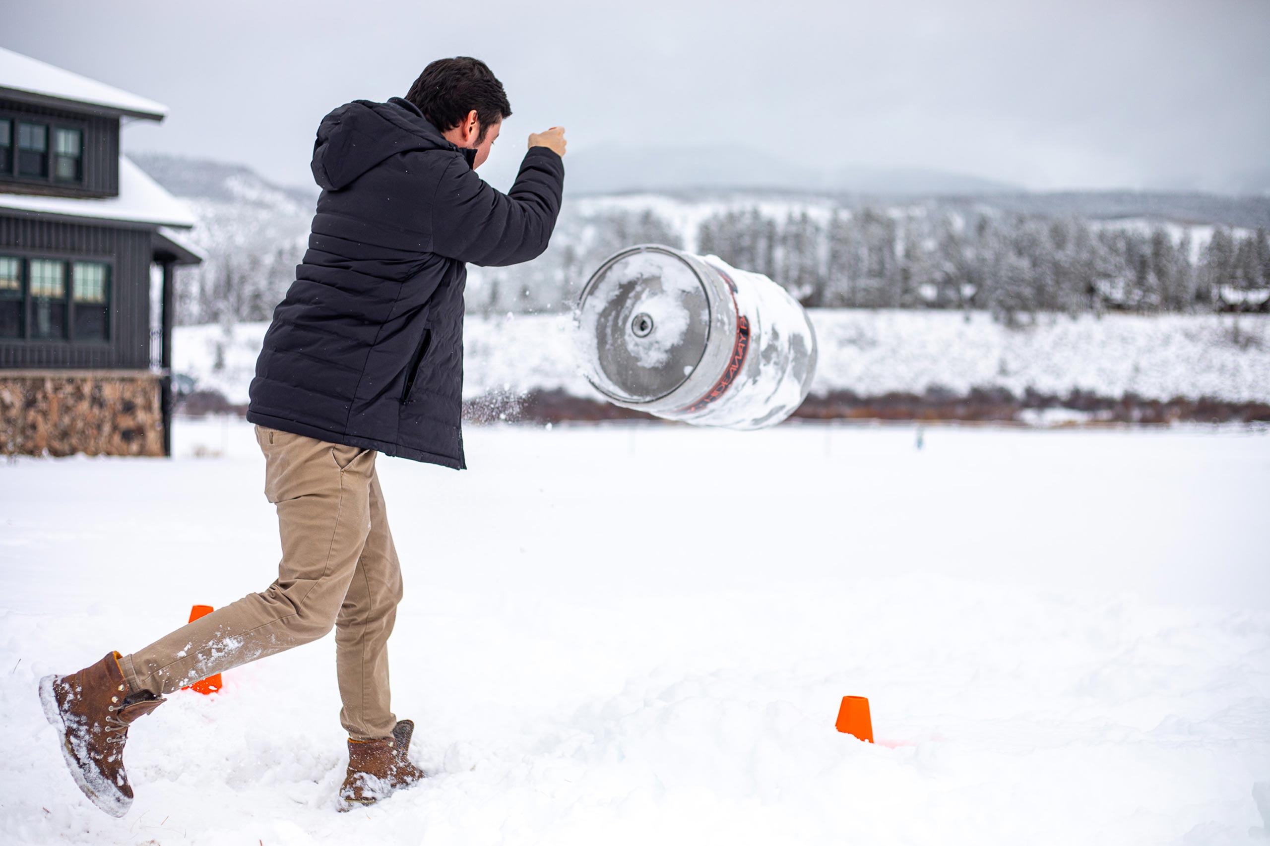 Man throwing a snowball in a snowy landscape at Devil's Thumb Ranch.