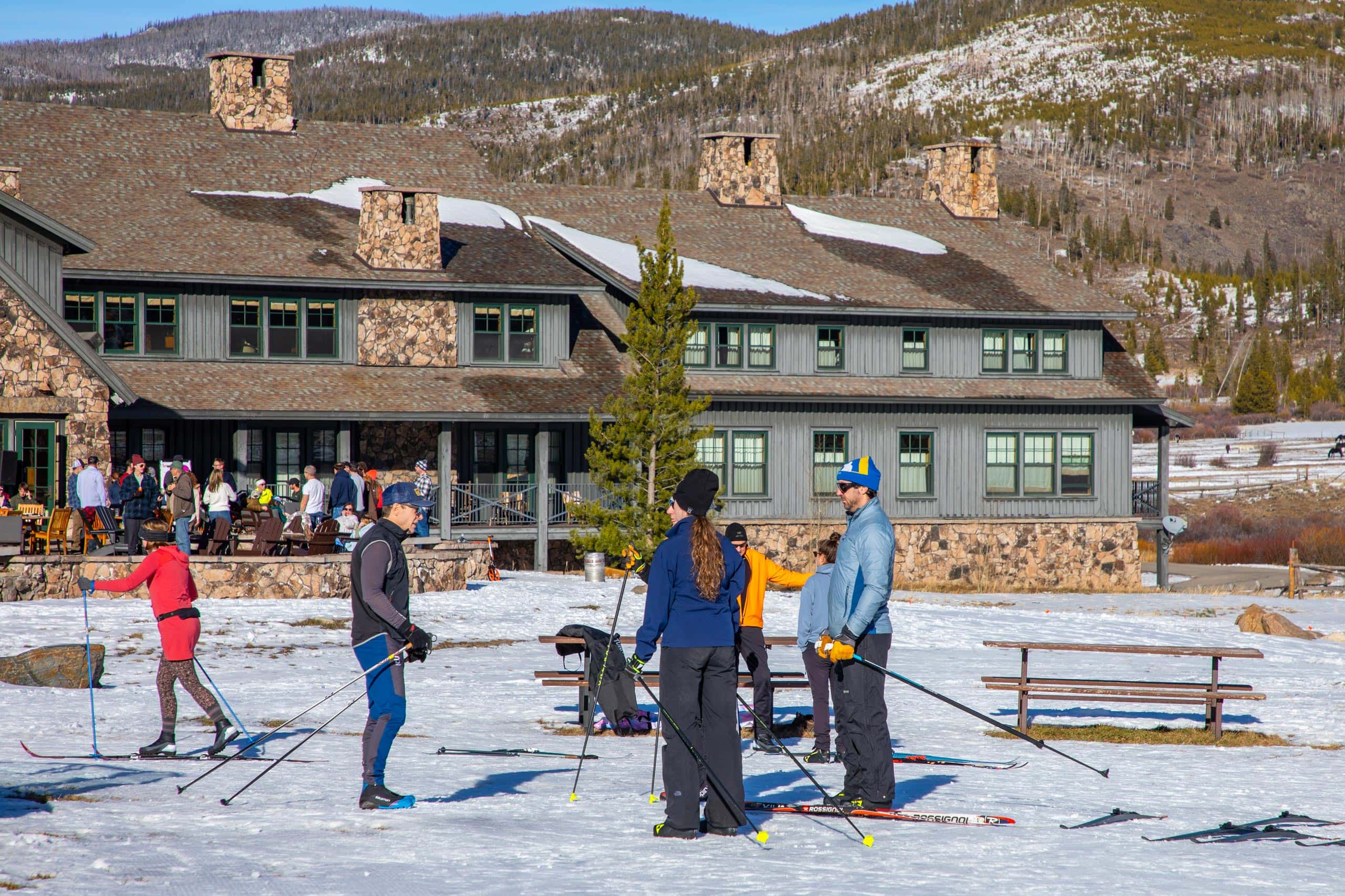 People skiing and snowboarding at Devil's Thumb Ranch in winter.